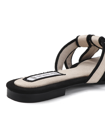 White Black two-tone canvas slides with woven straps and studded trim Flats